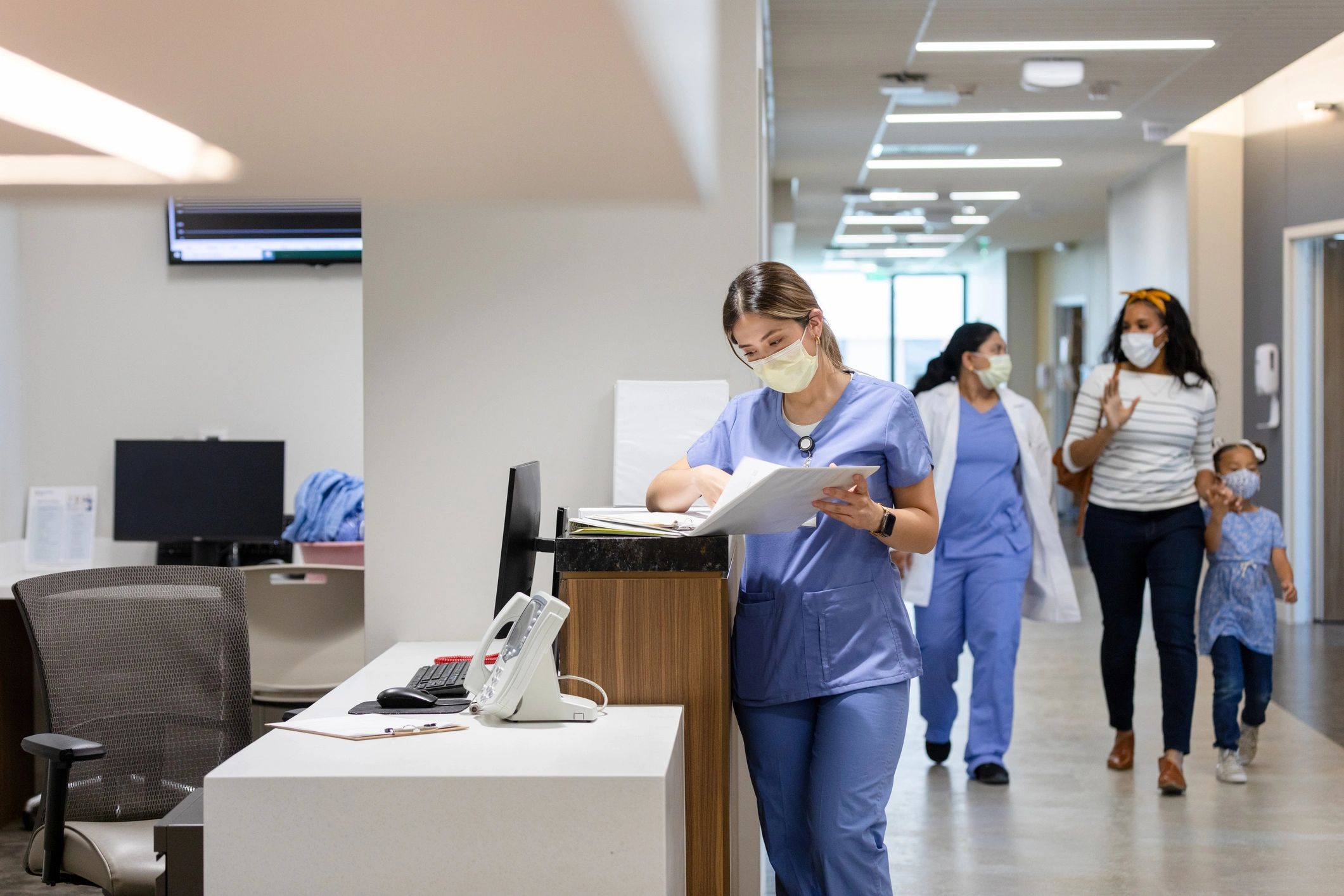 Clinician walking with a patient in a hospital hallway